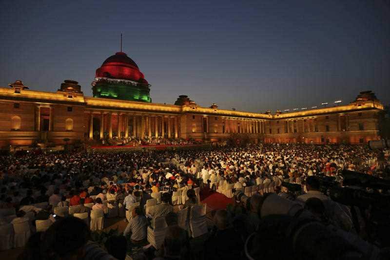 People watch the swearing in ceremony of Narendra Modi, for a second term as India's prime minister at the forecourt of presidential palace in New Delhi, India