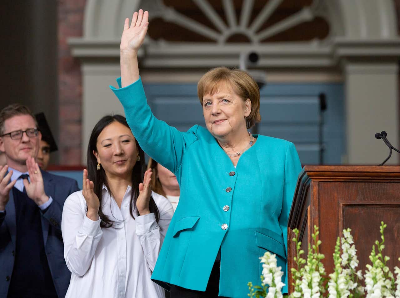 German Chancellor Angela Merkel waves to the audience following a speech to the Harvard Alumni and the Class of 2019.
