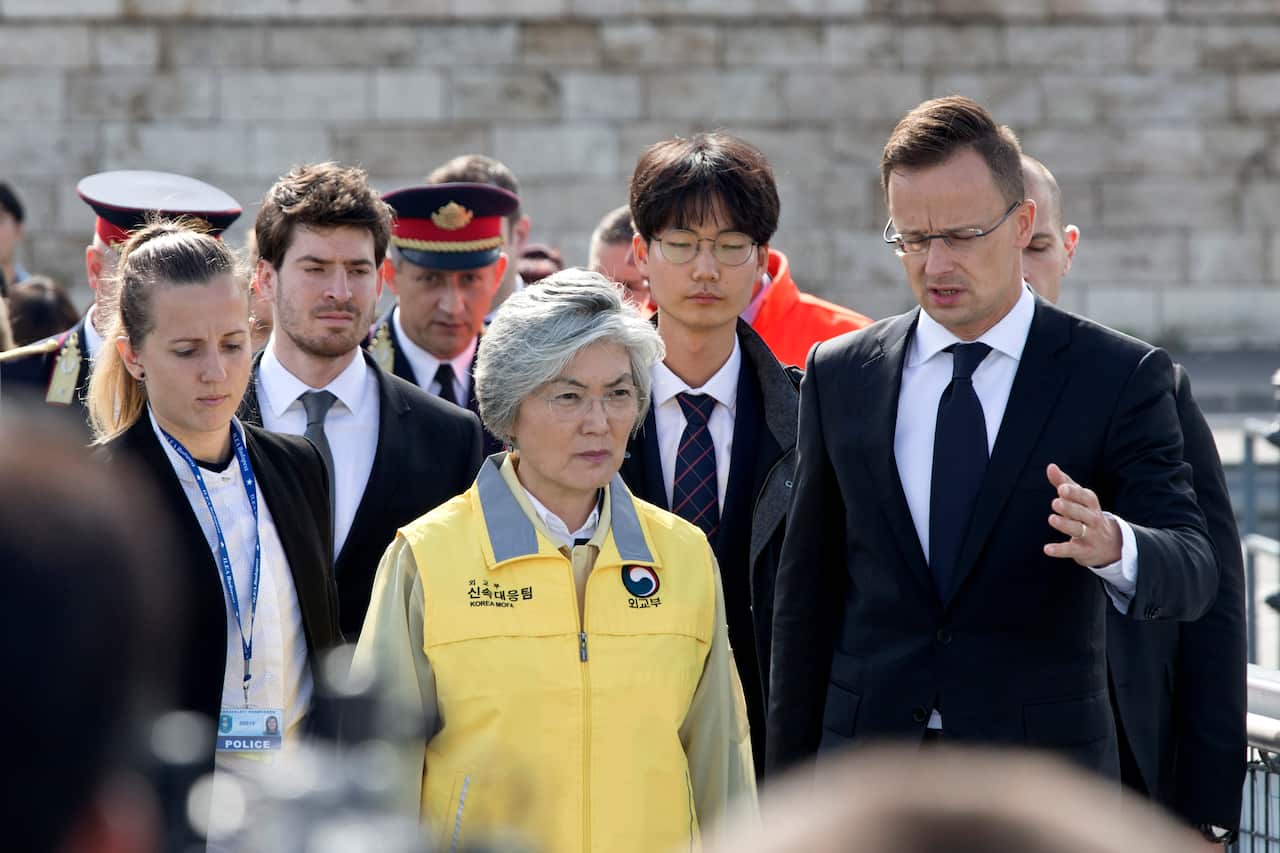 South Korean Foreign minister Kang Kyung-wha and her Hungarian counterpart Peter Szijjarto visit the bank of the Danube river where a sightseeing boat capsized.