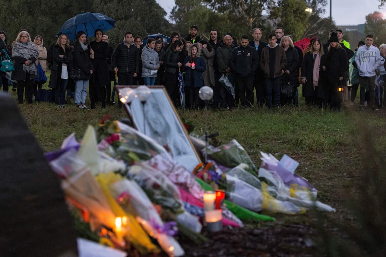 Mourners gather for the vigil for Courtney Herron, at Royal Park in Melbourne.