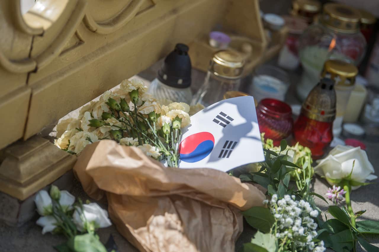 Flowers and candles are left in memory of the victims on the Margaret Bridge.