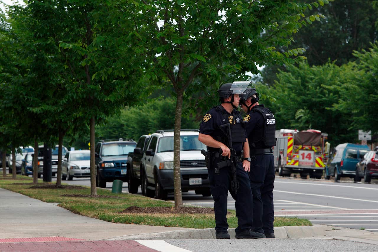 Virginia Beach Police Officers huddle near the intersection.