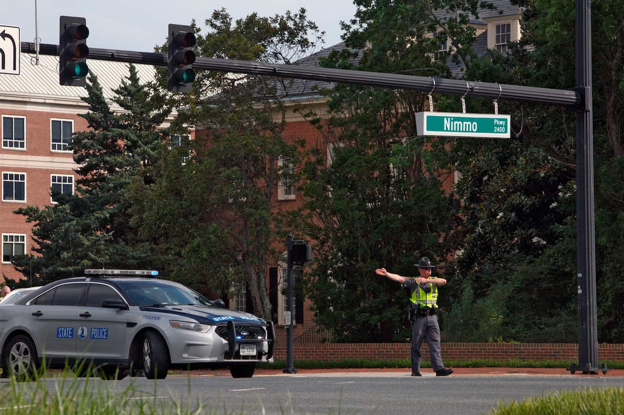 A police officer directs traffic away from the intersection.