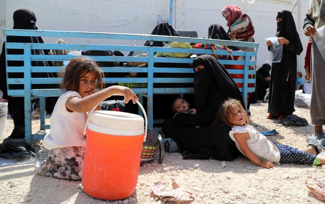 A file image of  a wife of an IS fighter with her children at the al-Hawl camp in northeastern Syria on 3 June 2019.