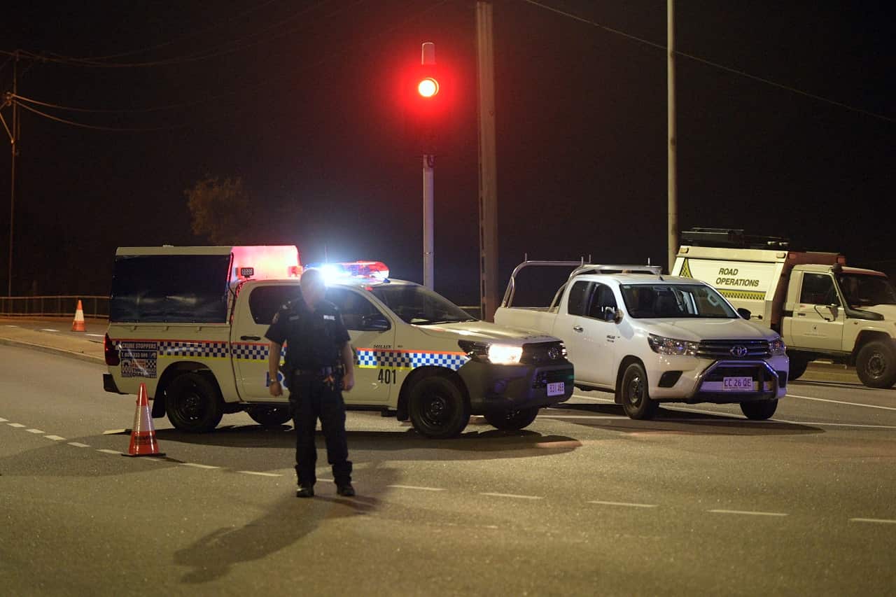 Police at a crime scene on the intersection of McMinn Street and Stuart Highway in Darwin.