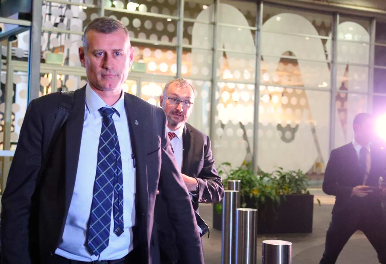 Two Australian federal Police officers walk out of the main entrance to the ABC building located at Ultimo in Sydney.