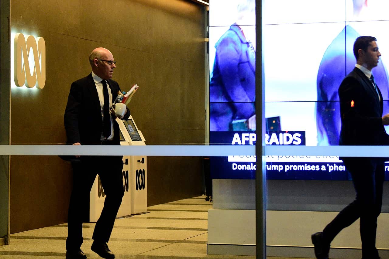 Australian Federal Police (AFP) investigators leaving the main entrance to the ABC.