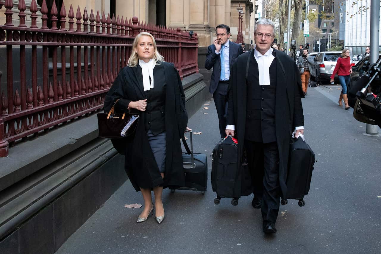 Prosecutors Angela Ellis (left) and Mark Gibson (right) leave the Supreme Court of Victoria in Melbourne.