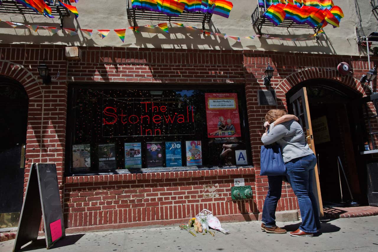 A couple embraces outside the Stonewall Inn in New York.