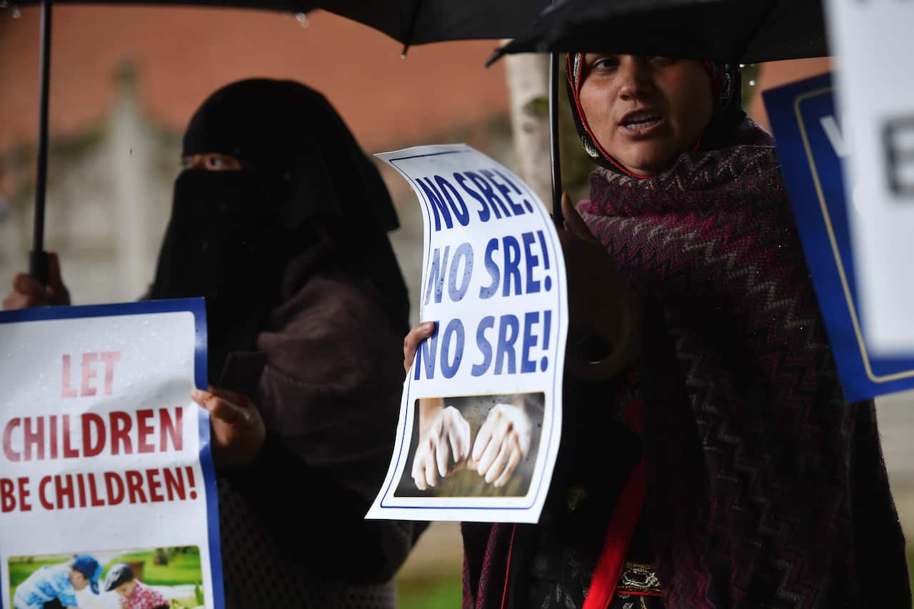 Protestors hold their first demonstration since an injunction was granted barring action immediately outside Anderton Park Primary School.