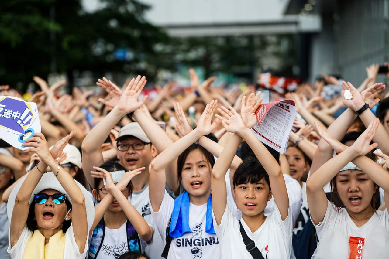Hong Kong protesters cross their arms to form the "No" symbol during the anti extradition law protest