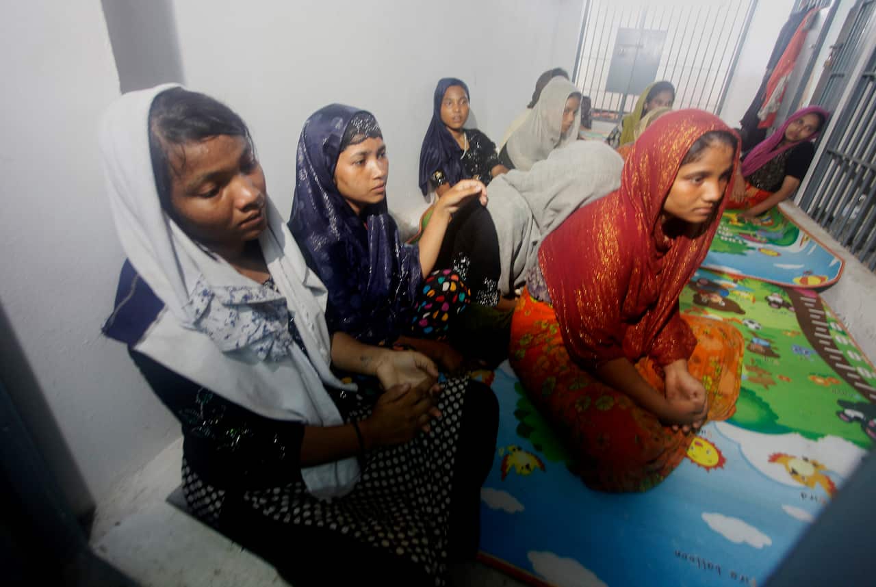 Rohingya sits behind bars at police station.