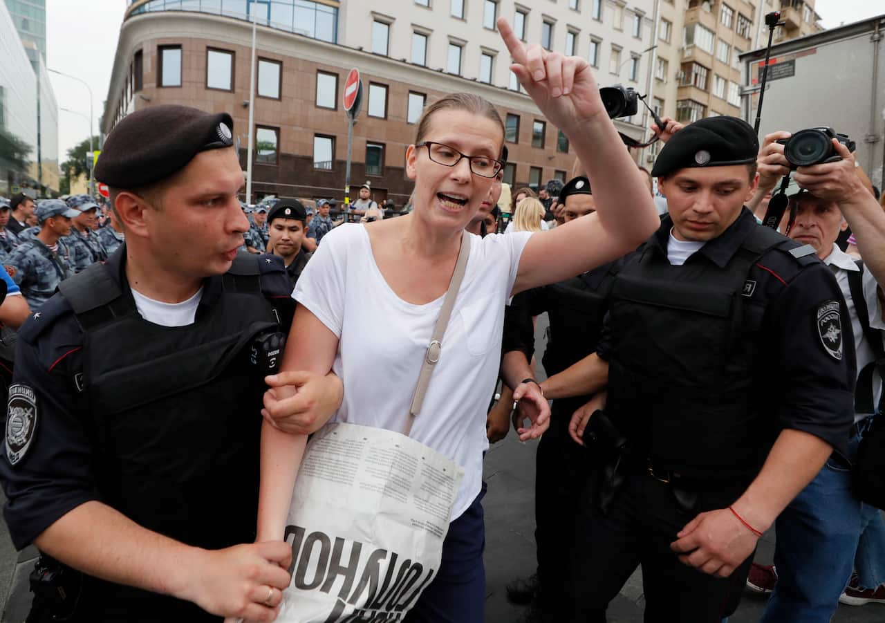 Russian national guard servicemen detain a participant of a protest action.