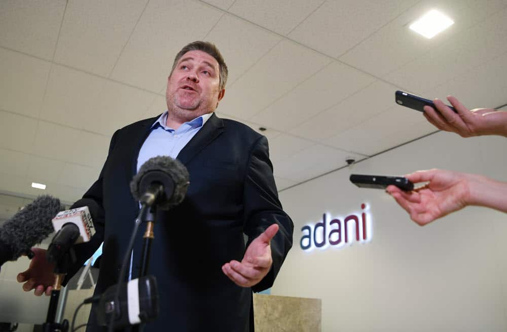 Adani Australia CEO Lucas Dow speaks at a press conference at the company's office in Brisbane. The Queensland government has started prosecution.