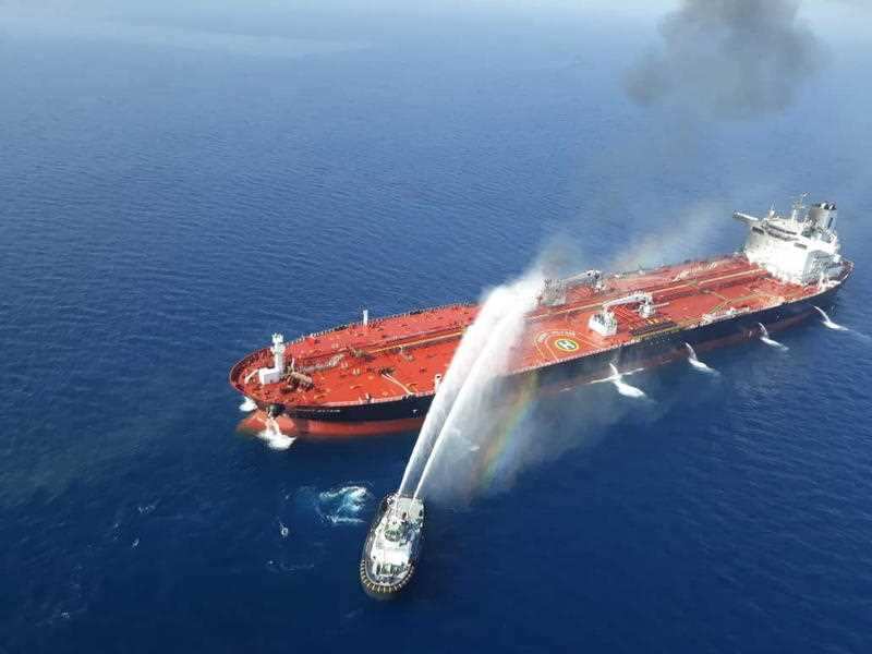 An Iranian navy boat try to control a fire on the crude oil tanker Front Altair in the Gulf of Oman, 13 June 2019. 
