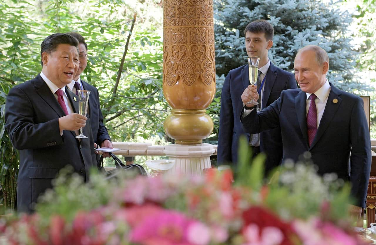 Russian President Vladimir Putin toasts with Chinese President Xi Jinping prior in Dushanbe, Tajikistan on Friday, June 14. 