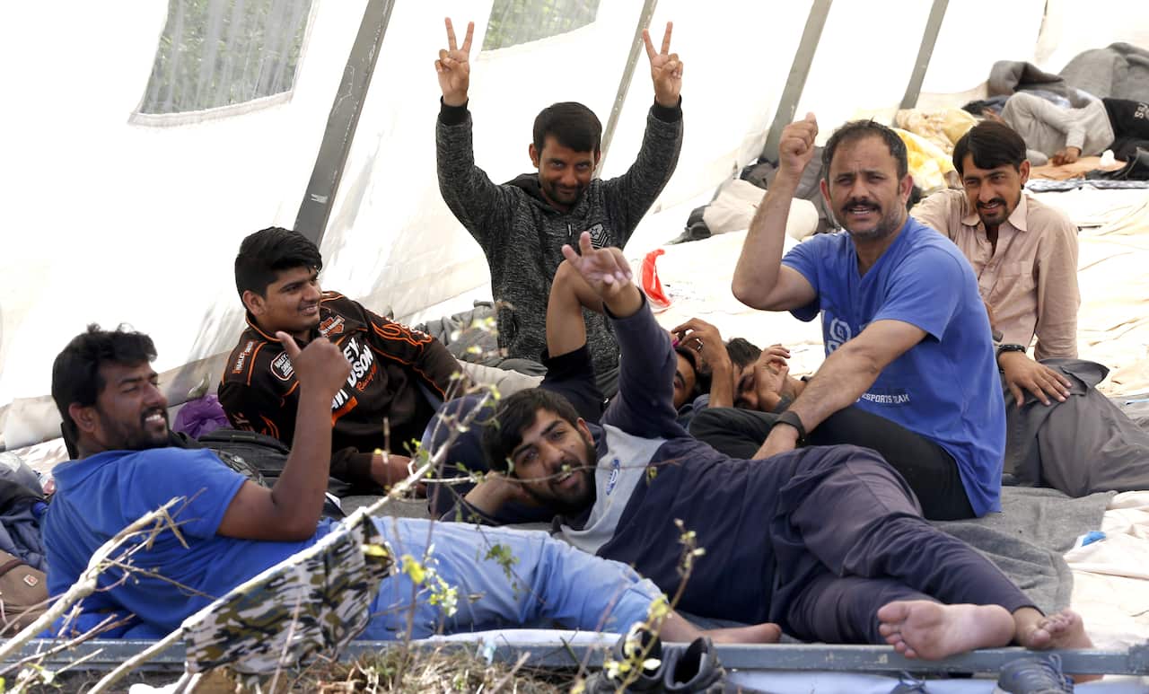 Migrants and refugees sit at a tent camp in Bihac, Bosnia and Herzegovina, 16 June 2019. 