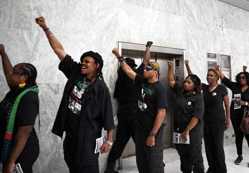 Members of the New Black Panther Party gathered in the hallway outside the hearing 