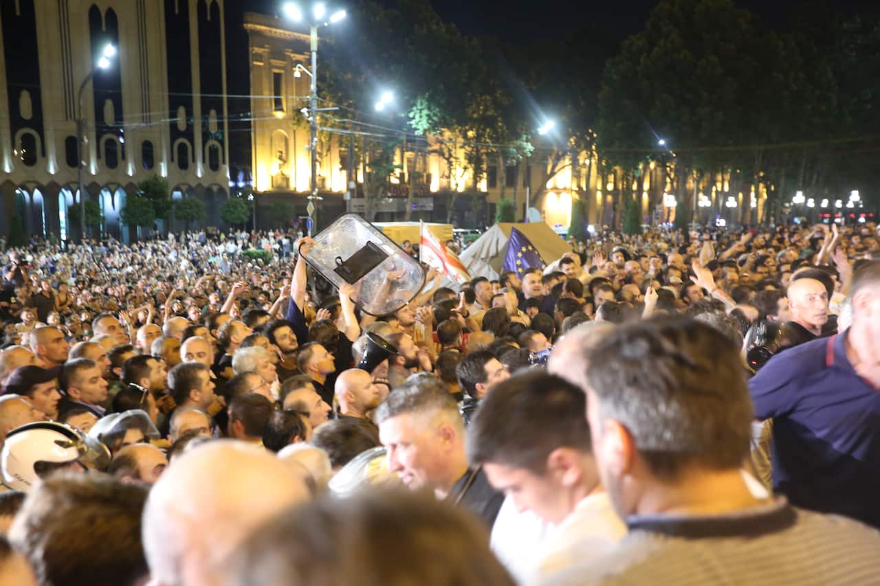 Protestors clash with riot police during a mass rally in front of the Parliament building in Tbilisi, Georgia.
