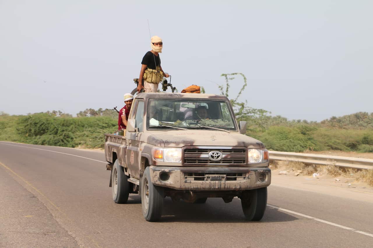 Yemeni government forces advance during fighting against Houthi rebels.