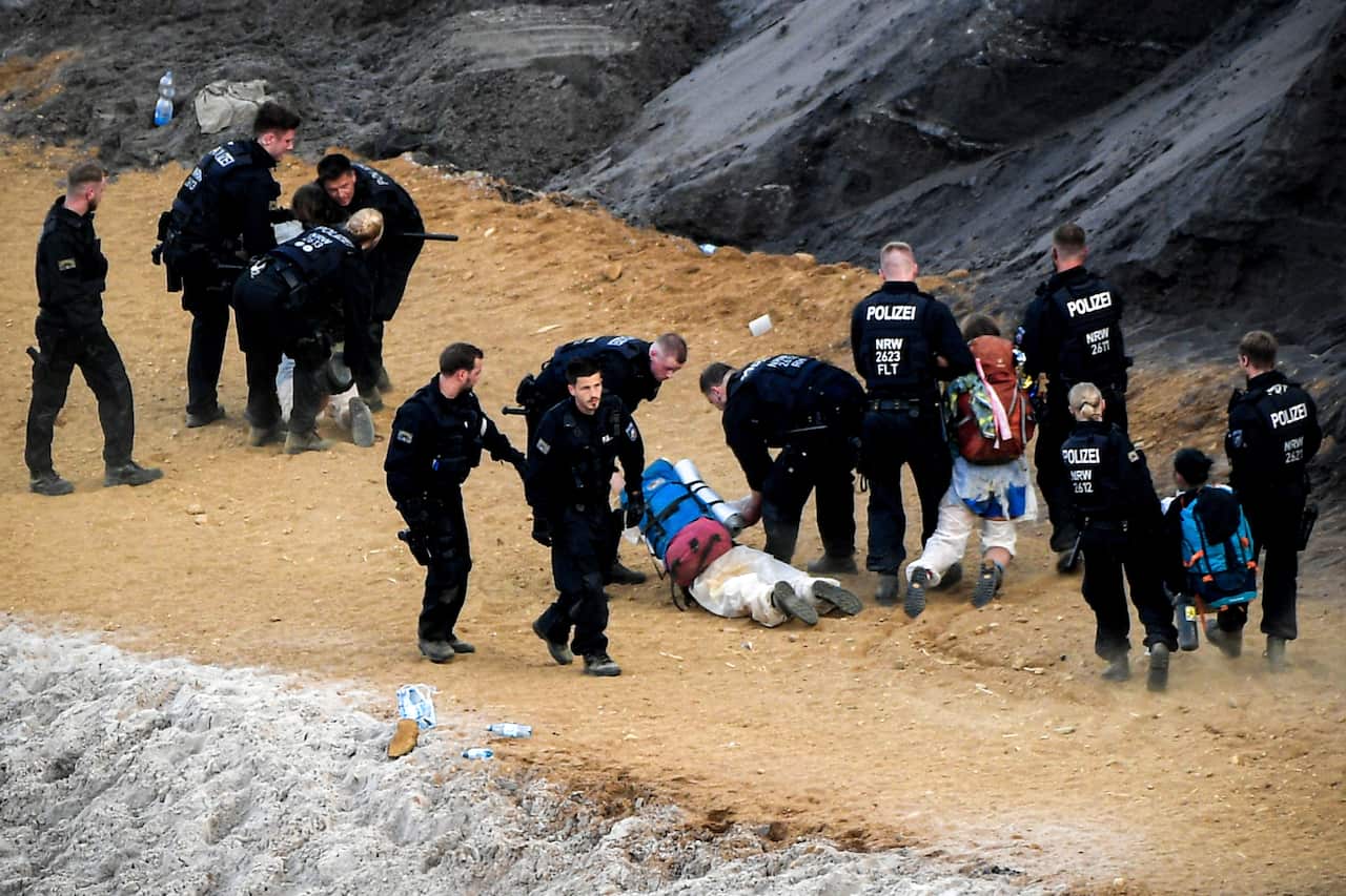 Activists taking part in the 'Ende Gelaende' protest initiative face a police cordon in a pit in the Rhenish coal mining area in western Germany.