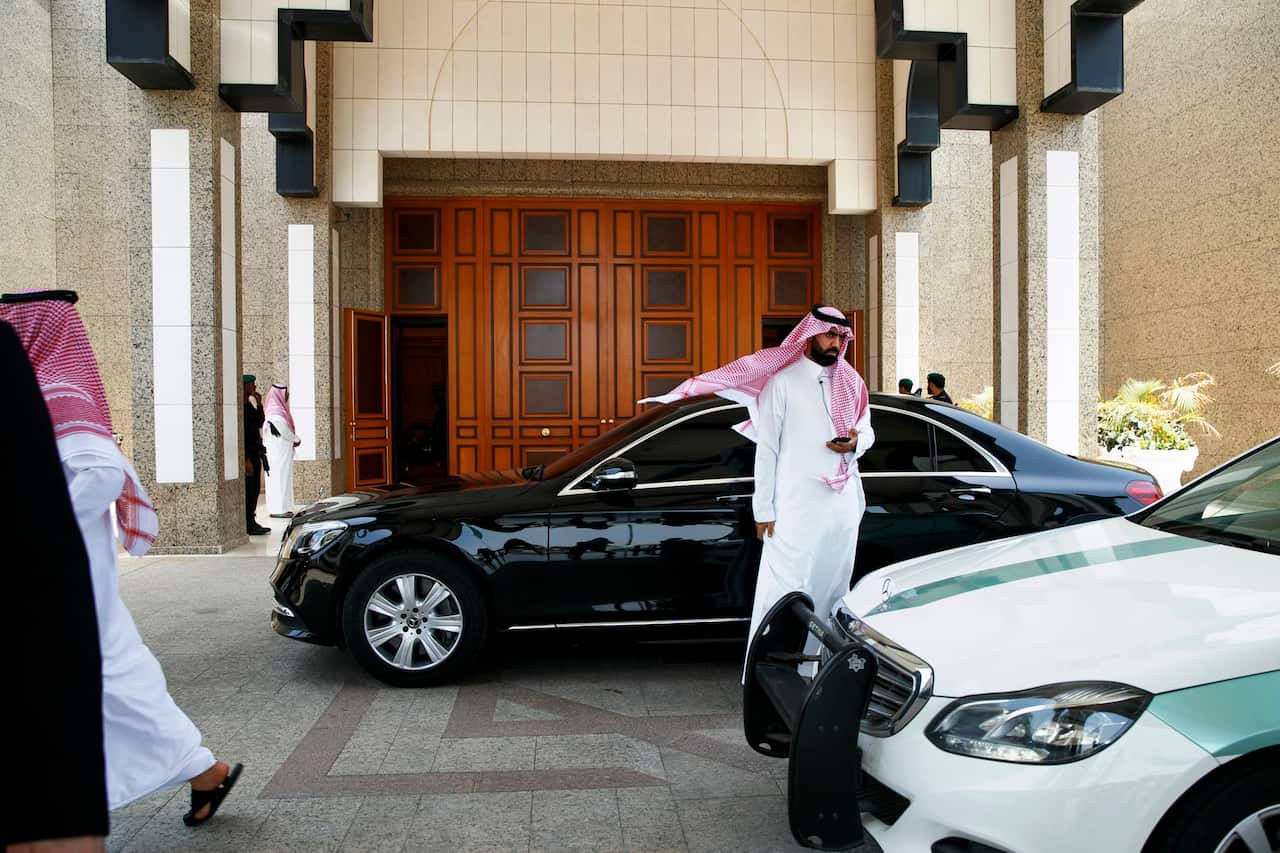 Saudi Arabian men walk outside of Al-Salam Palace as Secretary of State Mike Pompeo meets with Saudi Arabia's Crown Prince Mohammed bin Salman inside, Monday, June 24, 2019, in Jiddah, Saudi Arabia. (AP Photo/Jacquelyn Martin, Pool)