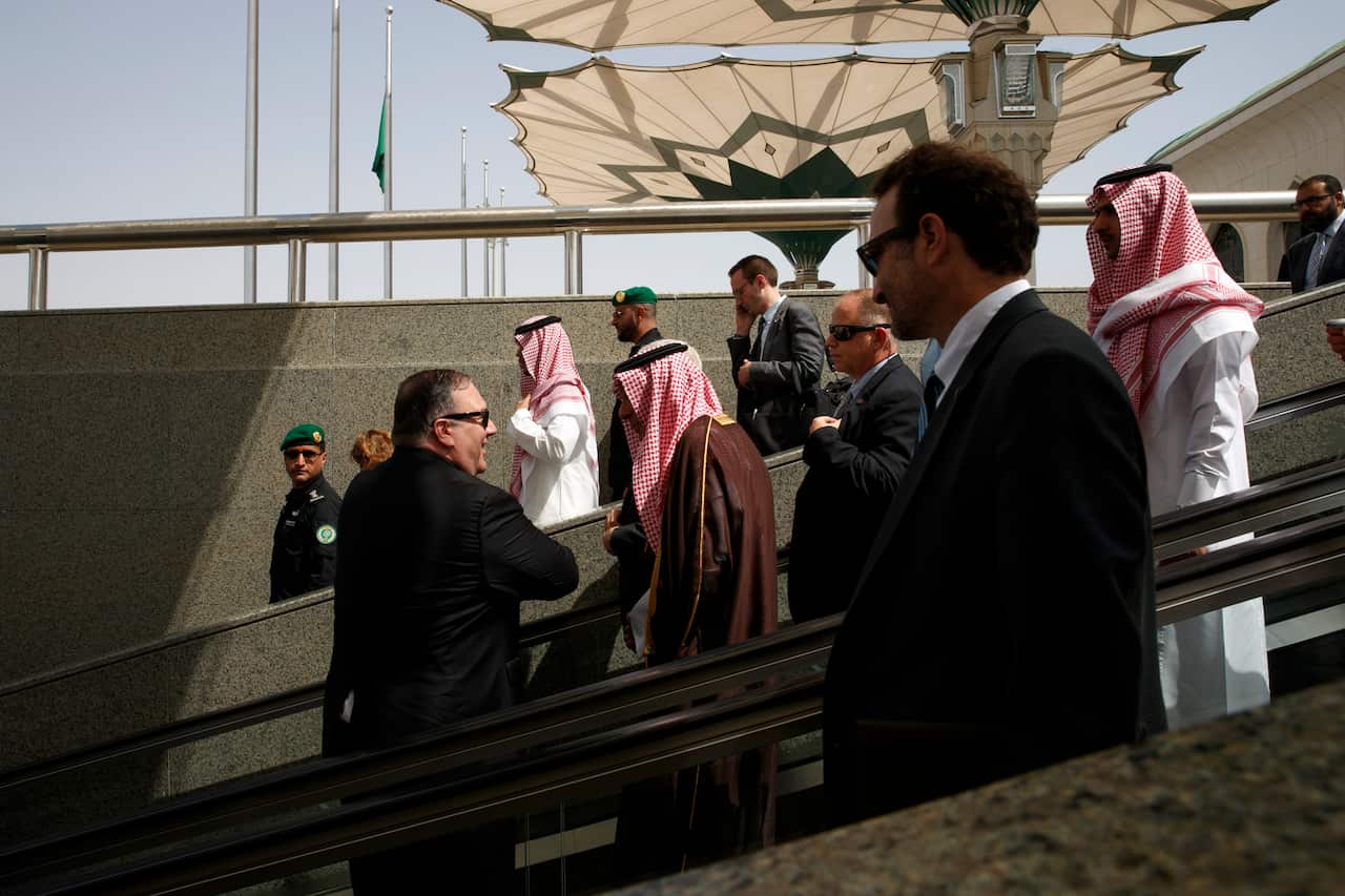 Secretary of State Mike Pompeo, left, chats with Minister of State for Foreign Affairs Adel al Jubeir, on an escalator at the airport as Pompeo departs Jiddah, Saudi Arabia, Monday, June 24, 2019, en route to Abu Dhabi. (AP Photo/Jacquelyn Martin, Pool)