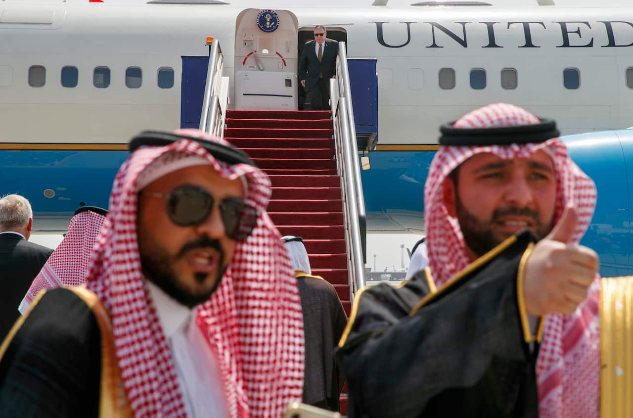 Secretary of State Mike Pompeo, center, exits a plane on arrival to Jeddah, Saudi Arabia.