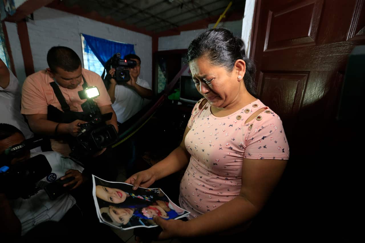 Rosa Ramirez cries when shown a photograph of her son Oscar Ramirez, granddaughter Valeria, nearly 2, and her daughter-in-law Tania Avalos