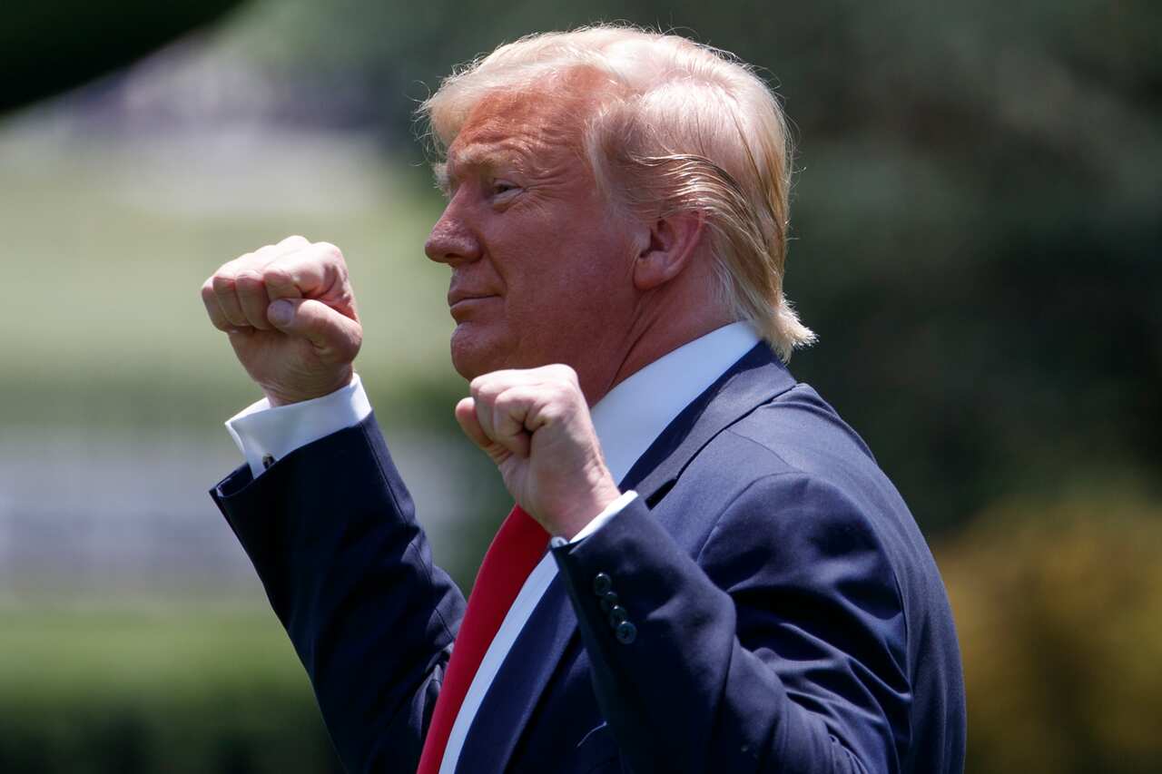 President Donald Trump gestures as he walks to Marine One across the South Lawn of the White House in Washington.