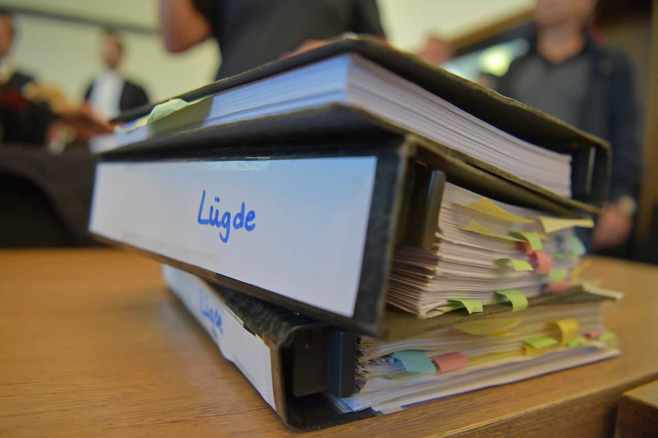 Process files lie on the defending counsel's desk prior to the arrival of defendants Andreas V., 56, Mario S., 34, and Heiko V., 49, on the first day of their trial