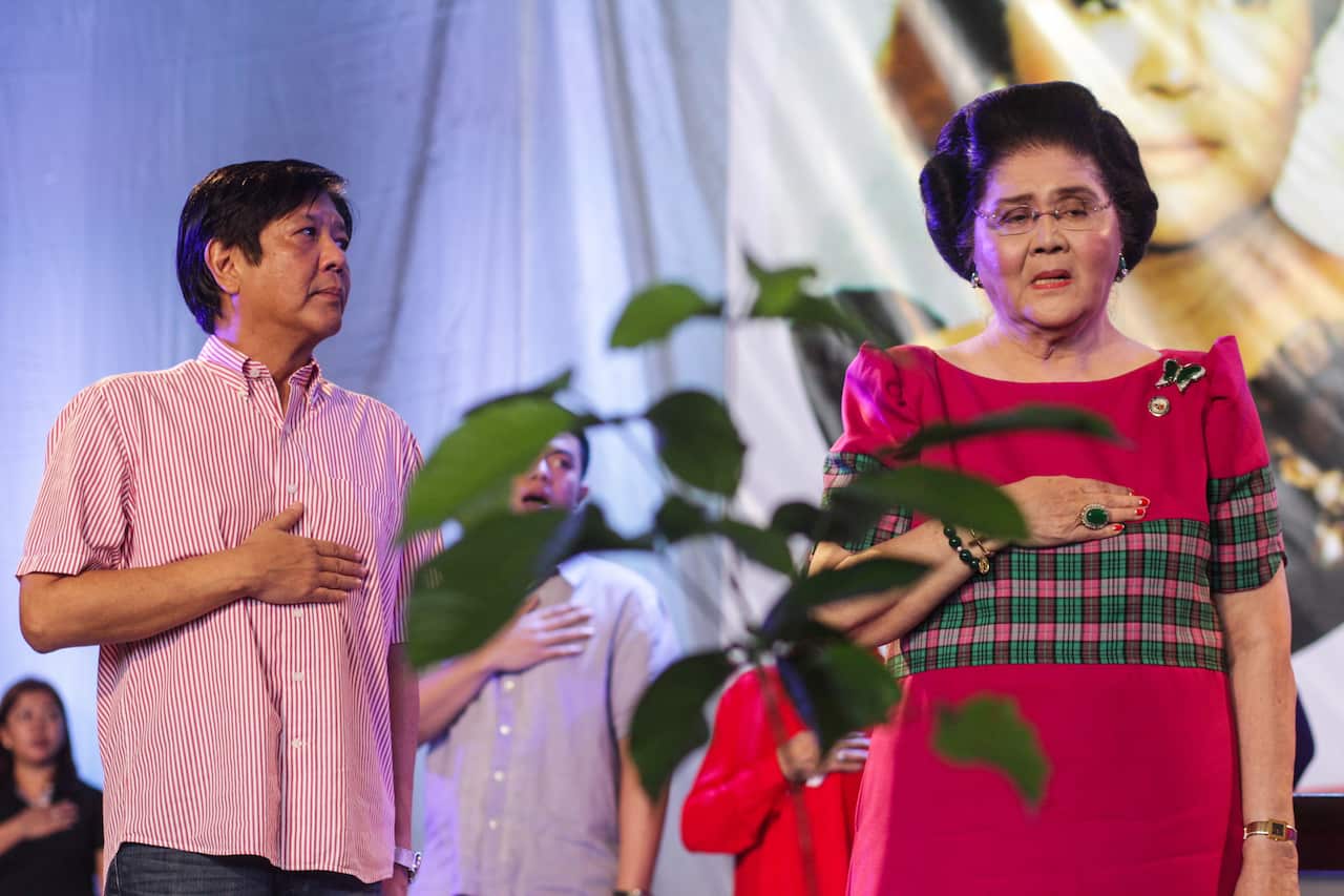 Filipino former First Lady Imelda Marcos with her son Bongbong at her 90th birthday celebration.