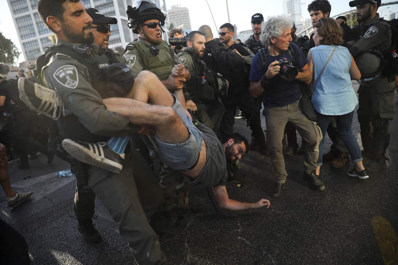 Police arrest a a man during a protest in Tel Aviv, Israel, Wednesday, July 3, 2019.