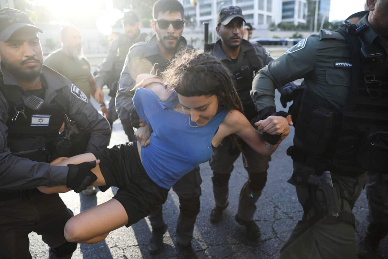 Police detain a woman during a protest in Tel Aviv, Israel, Wednesday, July 3, 2019.