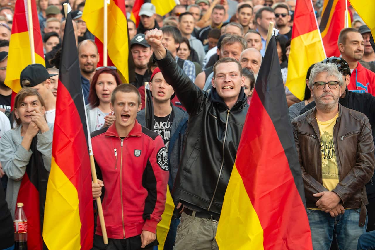 People attend a demonstration in Chemnitz after several nationalist groups called for marches protesting Mr Hillig's death, 2018.