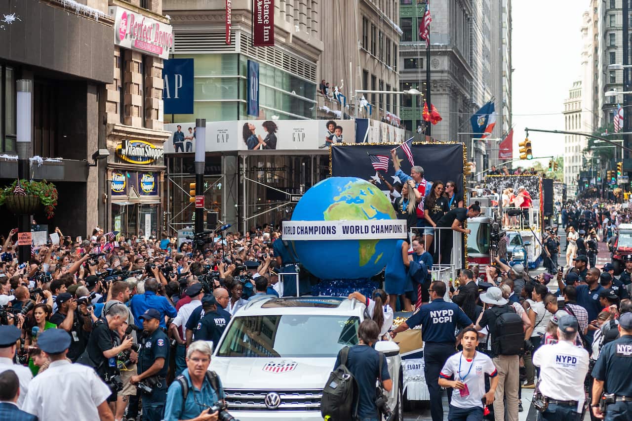 PHOTO: Soccer fans line up in the Canyon of Heroes in lower Manhattan to celebrate the U.S. Women's National team's 4th FIFA World Cup win with a ticker tape parade on 10 July 2019.