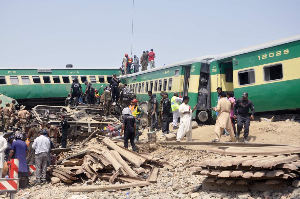 Rescue workers at the scene of a train accident near Sadiqabad, Pakistan