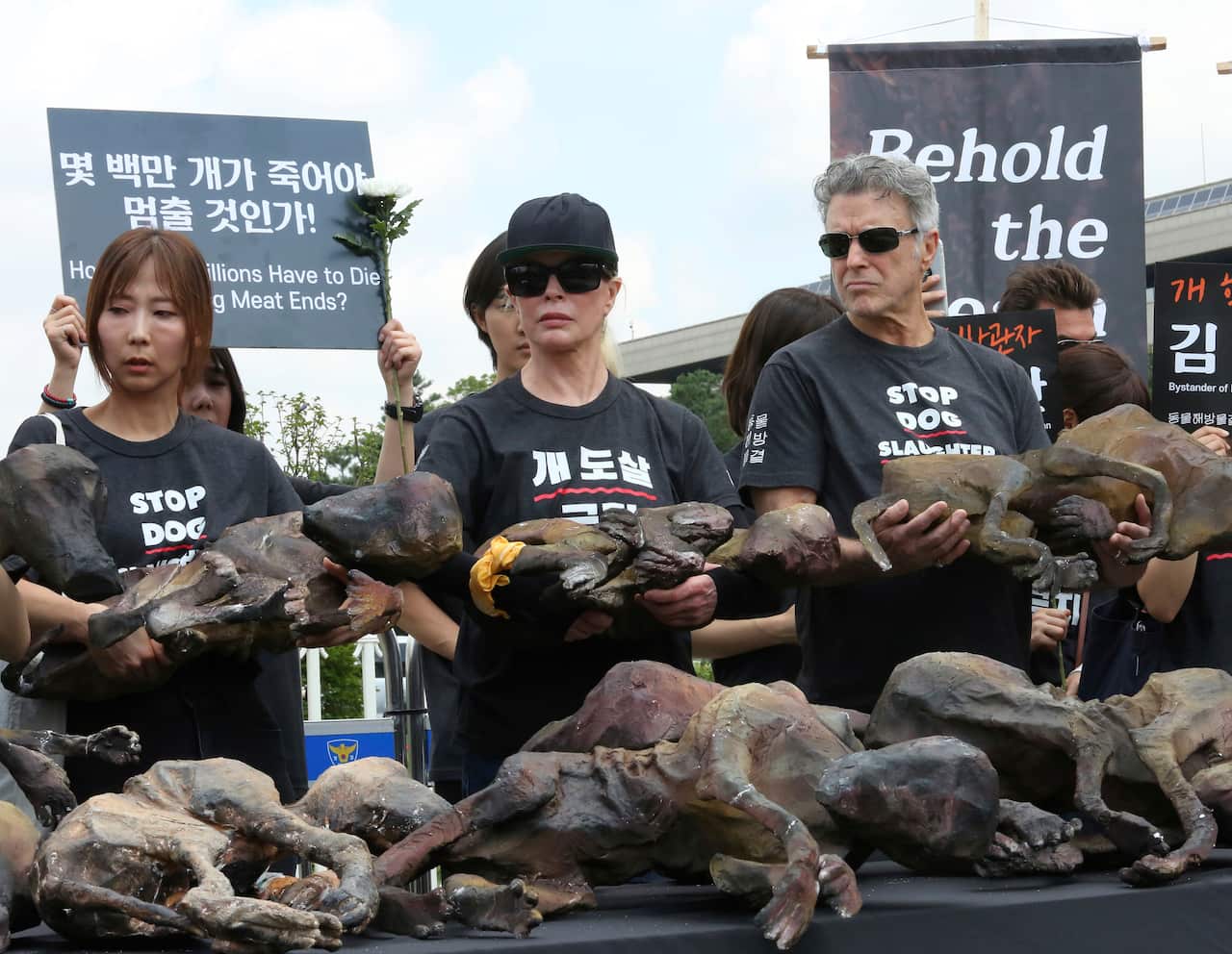 American actress Kim Basinger, center, holds a model of the slaughtered dogs.