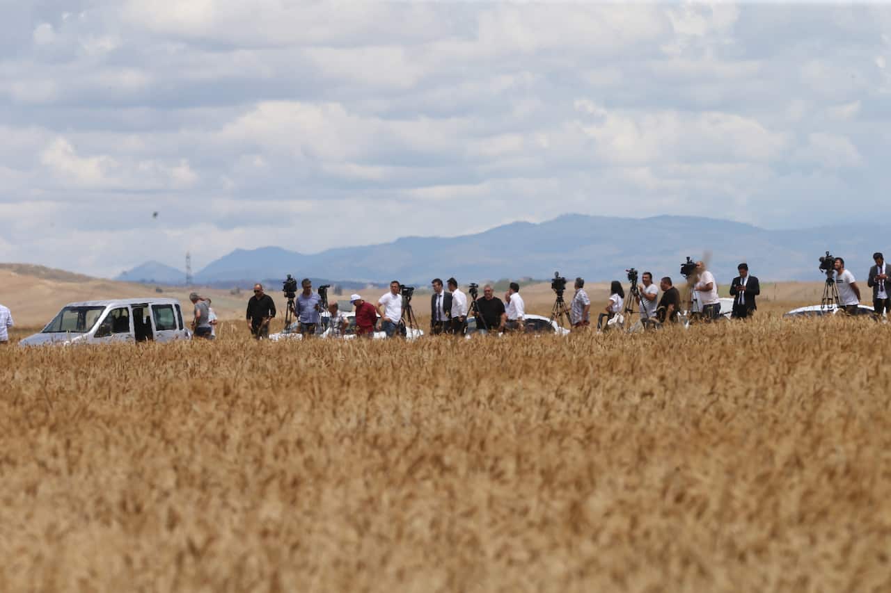 Journalists follow to a Russian millitary cargo plane believed to be carrying parts of the Russian S-400 anti-aircraft missile system.
