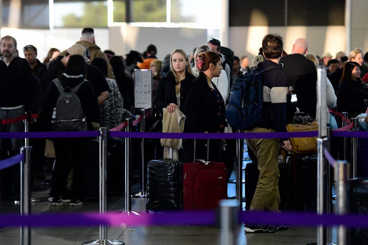 People are seen lining up at Sydney Airport, Sydney.