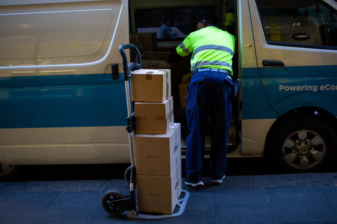 A courier driver unloads packages in Sydney's CBD.