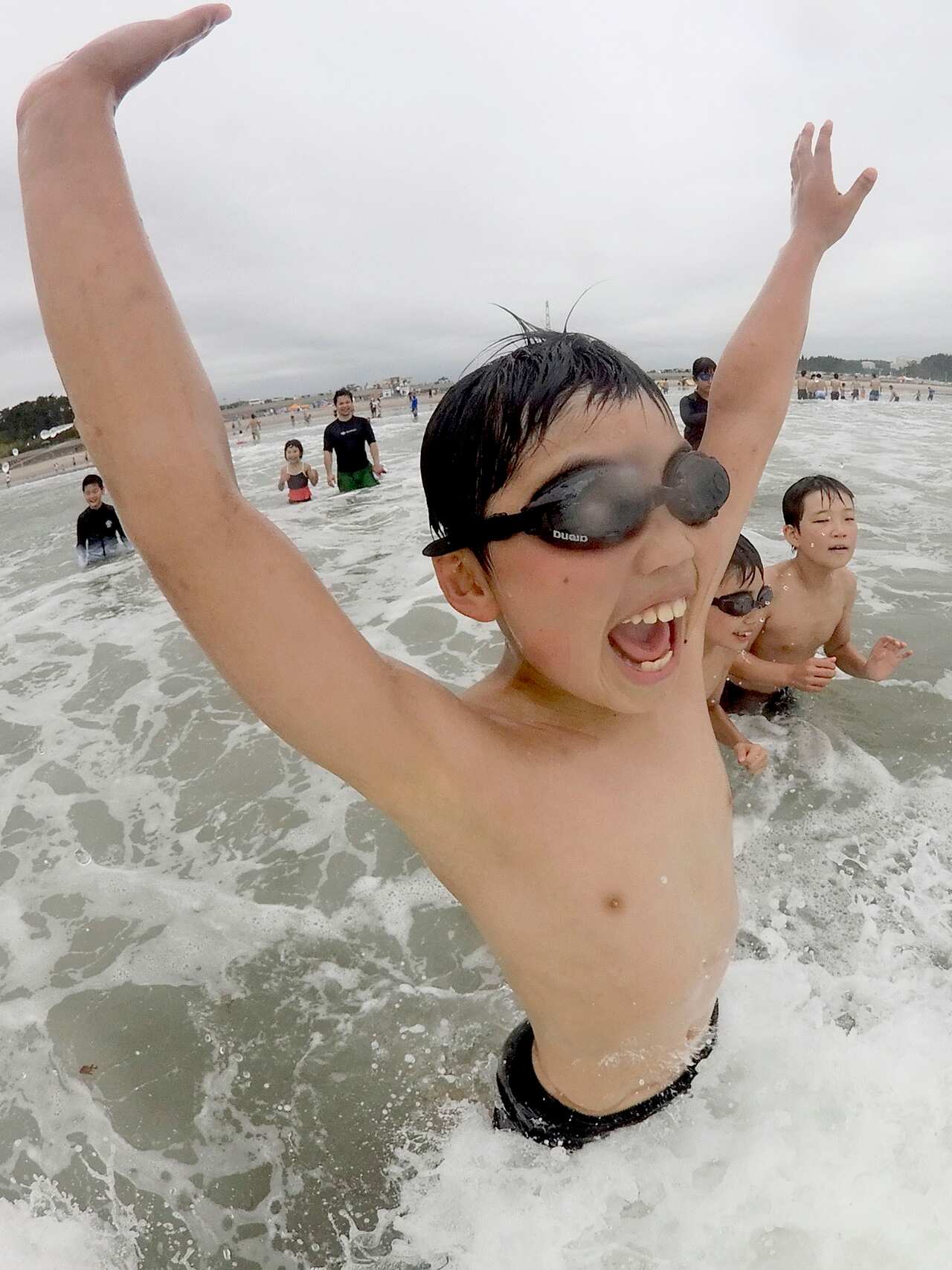 Children play after the beach opened to the public for the first time since it was struck by the 2011 earthquake-tsunami disaster.