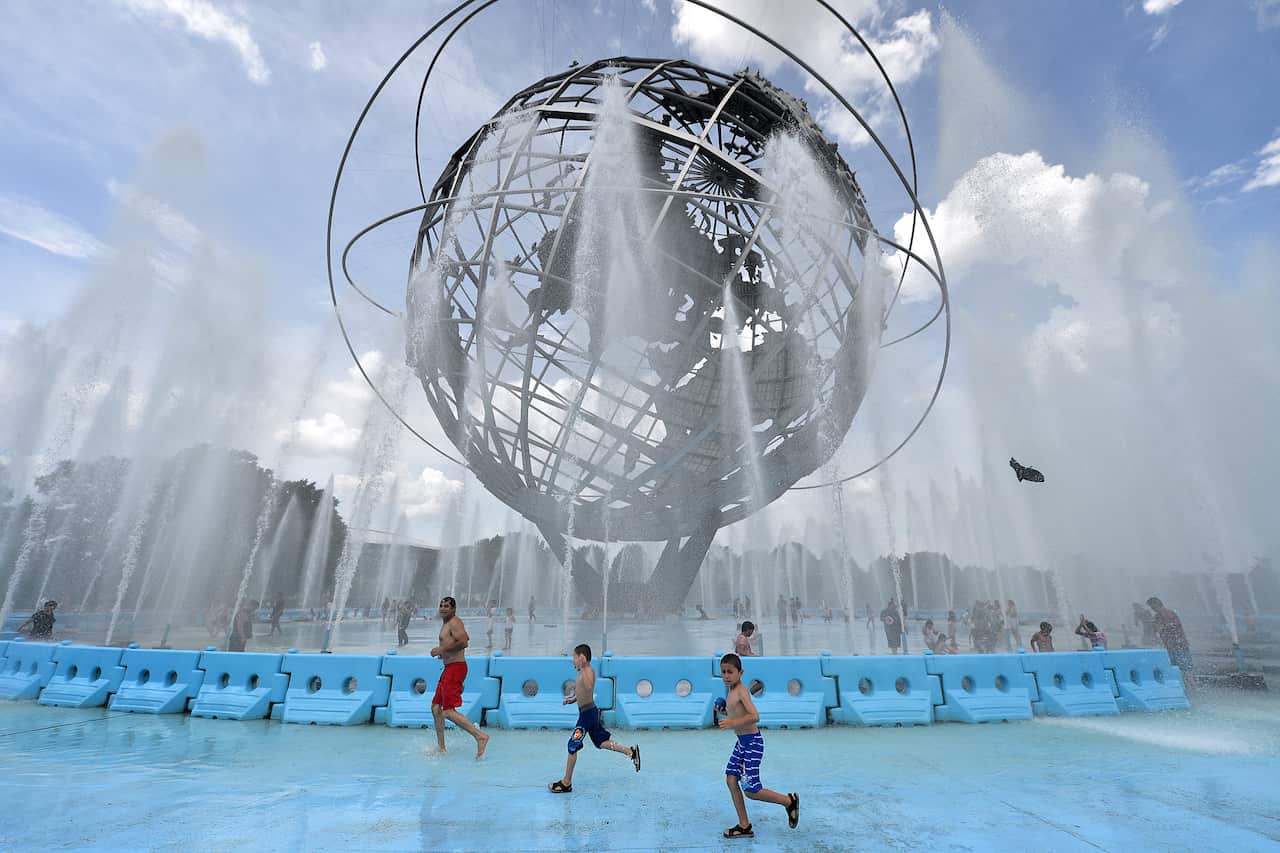 Children play in the Unisphere fountain in New York to cool off.