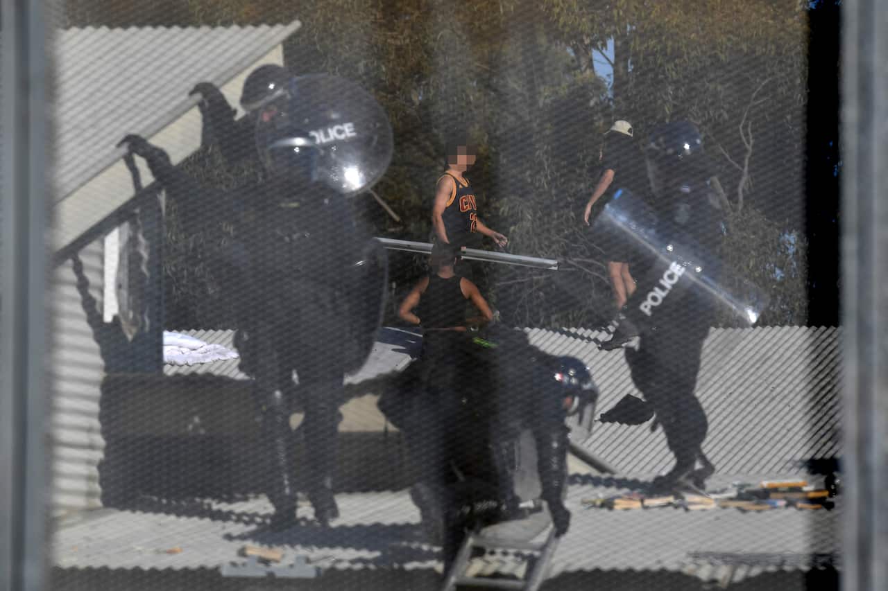 Detainees and Riot police are seen during a riot at the Frank Baxter Juvenile Justice Centre, Kariong, NSW last week. 