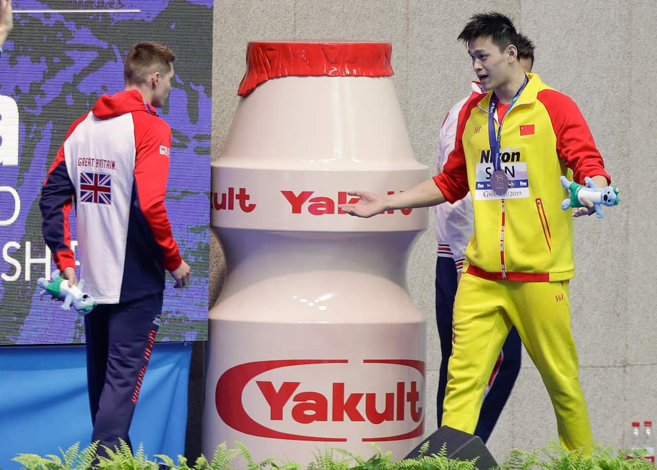 China's Sun Yang, right, gestures to Britain's Duncan Scott following the medal ceremony in the men's 200m freestyle final.