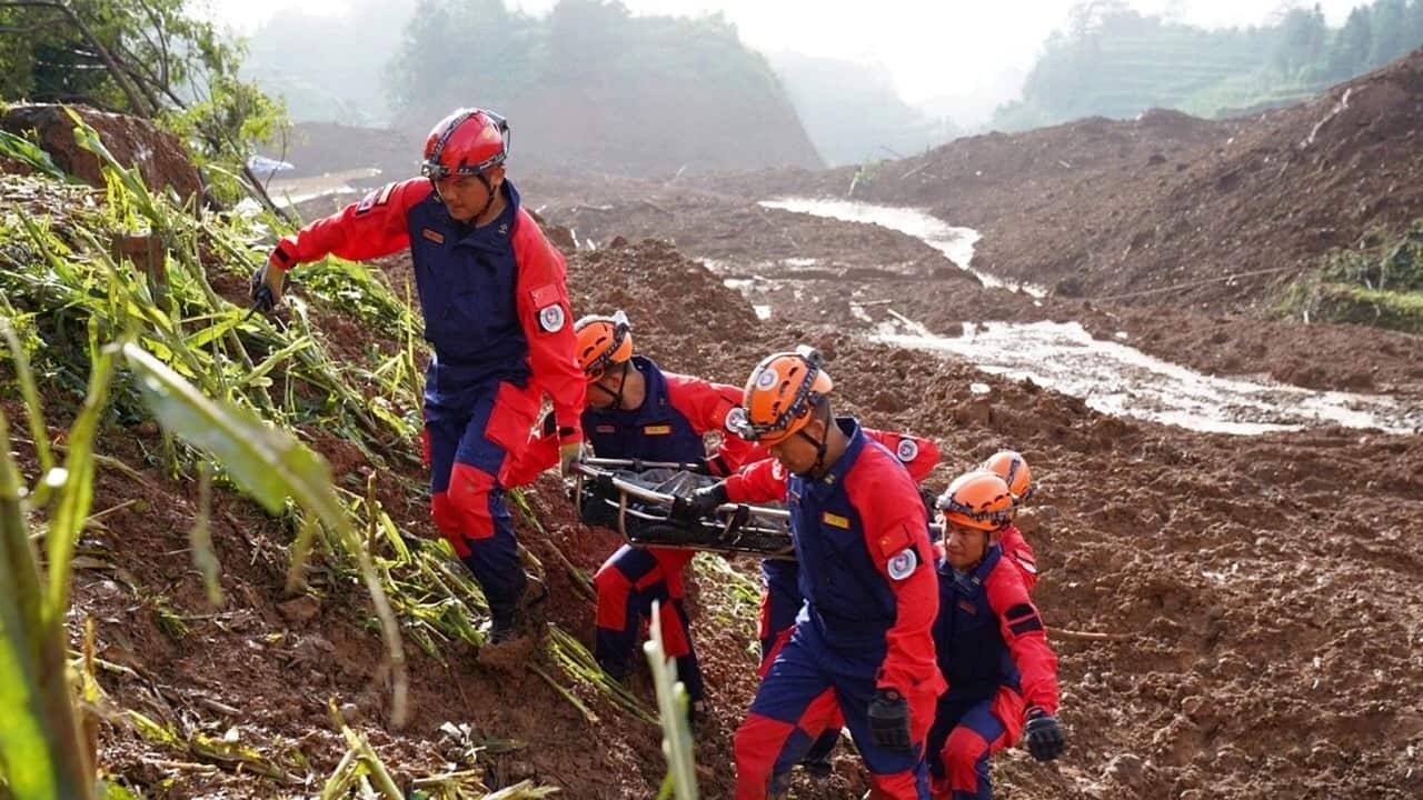 Chinese rescuers search for victims and survivors after the landslide.