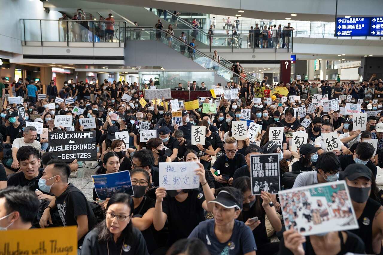 Demonstrators holding placards during the sit in protest at the airport arrival hall.