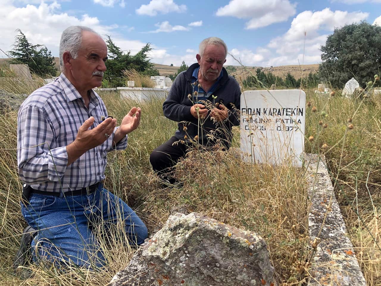 Adem Karaagac, left, and Satilmis Karatekin pray at the grave of a distant relative of Boris Johnson.