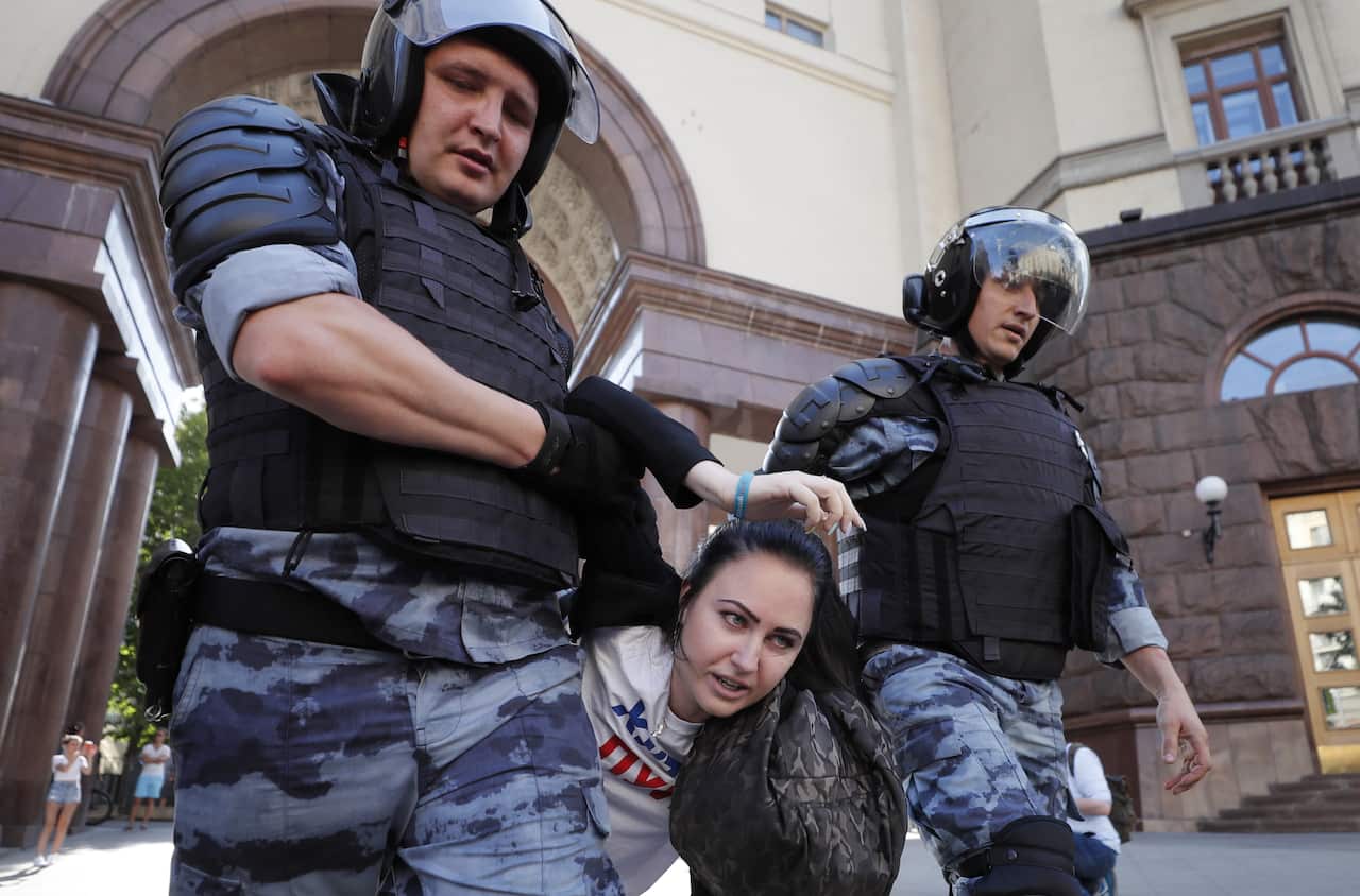 Russian riot police detain a participant during a liberal opposition protest in front of Moscow Mayor's office in Moscow, Russia, 27 July 2019.