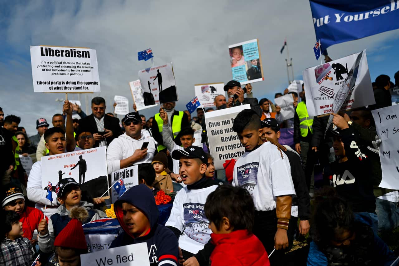 Children are seen attending a rally by Temporary Protection Visa (TPV) and Safe Haven Enterprise Visa (SHEV) holders outside Parliament House in Canberra, Monday, 29 July, 2019. (AAP Image/Lukas Coch) NO ARCHIVING
